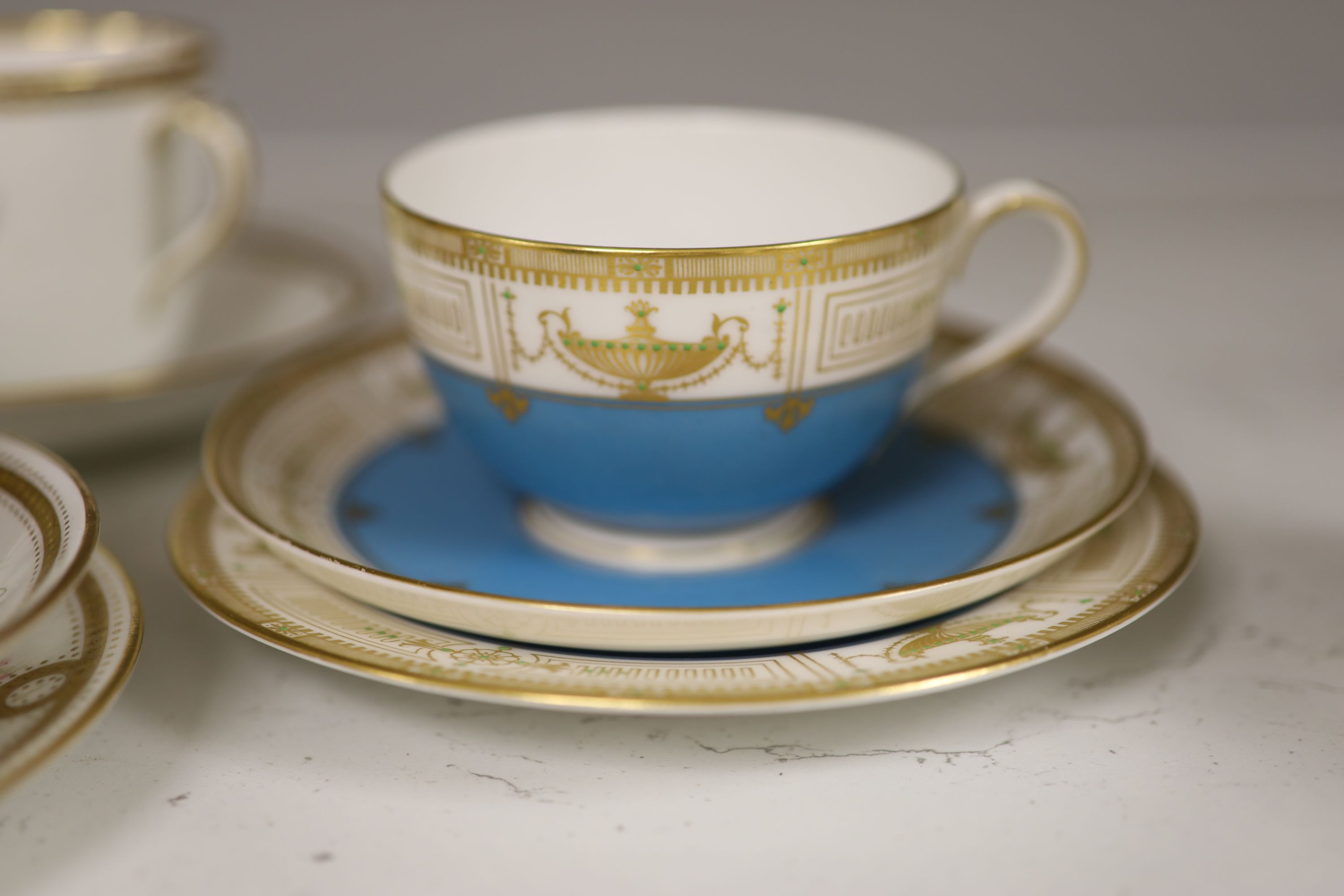 A Royal Worcester jewelled coffee cup and saucer painted with heathers by George Hundley, a Royal Worcester jewelled trio with gilt cla